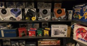 Multiple GameCube consoles and other special Nintendo objects next to each other