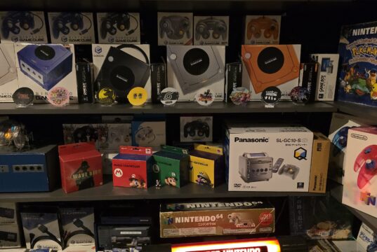 Multiple GameCube consoles and other special Nintendo objects next to each other